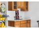 Kitchen counter with oak cabinets and stone countertops, showcasing stylish decor and natural light at 6506 Lee St, Arvada, CO 80004
