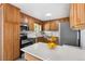 Well lit kitchen with updated stainless steel appliances and wooden cabinets at 6506 Lee St, Arvada, CO 80004