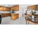 An open concept kitchen and dining area features wooden cabinets and stainless steel appliances at 6506 Lee St, Arvada, CO 80004