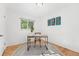 Bright room featuring hardwood floors, neutral walls, a decorative rug, and a chair with a wood desk, perfect office space at 6506 Lee St, Arvada, CO 80004