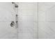 Modern shower with marble-look tile, sleek fixtures, and a built-in shower niche at 6506 Lee St, Arvada, CO 80004