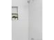 Sleek tiled shower with niche shelf showcasing green plants, offering a spa-like experience at 6506 Lee St, Arvada, CO 80004