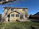 Well-maintained backyard featuring a spacious lawn, brick accents, and access to an outdoor patio at 13031 Dexter St, Thornton, CO 80241