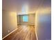 Finished room features laminate floors and a window, providing natural light at 13031 Dexter St, Thornton, CO 80241