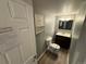 Well-lit bathroom with vanity, toilet, and storage cabinet at 13031 Dexter St, Thornton, CO 80241
