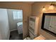 Cozy bathroom with a vanity, a cabinet and commode with a space for washer dryer at 13031 Dexter St, Thornton, CO 80241