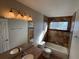 Bathroom featuring double sink vanity, tiled walls, and a bathtub and shower combo at 13031 Dexter St, Thornton, CO 80241