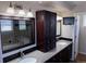 Well-lit bathroom featuring dual sinks, granite countertops, a large vanity, and a luxurious tub at 13031 Dexter St, Thornton, CO 80241