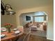 Open-concept dining area with modern table setting, seamlessly connecting to the living room at 13031 Dexter St, Thornton, CO 80241