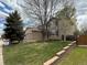 Beautiful home featuring well-kept lawn, brick accents, mature trees, and 'For Sale' sign at 13031 Dexter St, Thornton, CO 80241