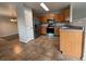 Well-lit kitchen with stainless steel appliances, wooden cabinets, and tile flooring at 13031 Dexter St, Thornton, CO 80241