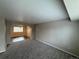 Cozy living room featuring neutral walls and plush carpet leading to the dining area at 13031 Dexter St, Thornton, CO 80241