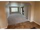 Spacious living area with neutral paint, plush carpet and views to front door and stairs at 13031 Dexter St, Thornton, CO 80241