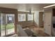 Living room with access to outdoor area with ceiling fan and natural light at 13031 Dexter St, Thornton, CO 80241