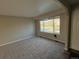 Inviting living room with plush carpeting and large windows providing ample natural light at 13031 Dexter St, Thornton, CO 80241