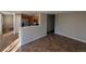Open-concept living space with tile floors seamlessly connecting the living room and kitchen area at 13031 Dexter St, Thornton, CO 80241