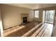 Comfortable living room with a cozy brick fireplace and a sliding door that offers natural light at 13031 Dexter St, Thornton, CO 80241