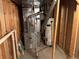 Utility room with a furnace, water heater, and exposed framing at 13031 Dexter St, Thornton, CO 80241