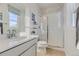 Bright bathroom with a white vanity, quartz countertop, stylish fixtures, and glass-enclosed shower at 13940 Hanging Lake St, Parker, CO 80138