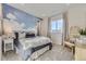 Bedroom featuring an accent wall with cloud design, plush bedding, and a cozy wicker chair at 13940 Hanging Lake St, Parker, CO 80138