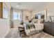 Comfortable bedroom featuring neutral tones, stylish décor, and a cozy bench at the end of the bed at 13940 Hanging Lake St, Parker, CO 80138