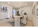 Chic dining room with a stylish chandelier, round table with upholstered chairs, and modern accents at 13940 Hanging Lake St, Parker, CO 80138