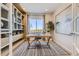 Well-lit home office features built-in shelving, a large window with a view, and modern decor at 13940 Hanging Lake St, Parker, CO 80138