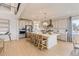 Spacious kitchen with a large island and barstool seating with open view to upper level and stainless steel appliances at 13940 Hanging Lake St, Parker, CO 80138
