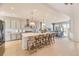 Bright, open kitchen with a large center island, modern appliances, and a seamless flow into the dining area at 13940 Hanging Lake St, Parker, CO 80138