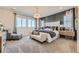 Spacious main bedroom with a cozy sitting area, plush carpeting, and stylish accent wall at 13940 Hanging Lake St, Parker, CO 80138