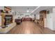 Spacious finished basement area with a fireplace, wood floors and desk area at 14447 Madison St, Thornton, CO 80602