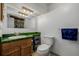 Bathroom with green countertop, light wood cabinet, and functional layout at 14447 Madison St, Thornton, CO 80602
