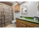 Cozy bathroom with a unique animal-themed shower curtain and wood vanity at 14447 Madison St, Thornton, CO 80602