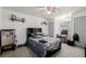 Bedroom with neutral carpet, comfy bed, mini fridge and accent chair at 14447 Madison St, Thornton, CO 80602