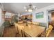Dining room with a wooden table, chairs, stairs and view into kitchen at 14447 Madison St, Thornton, CO 80602