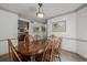 Elegant dining room featuring a wooden table, chairs, and decorative lighting at 14447 Madison St, Thornton, CO 80602