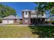 Two-story home featuring a brick facade, an attached garage, a front porch and a well-maintained lawn at 14447 Madison St, Thornton, CO 80602