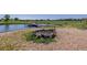 A cozy stone fire pit near the lake provides a perfect setting for outdoor gatherings at 14447 Madison St, Thornton, CO 80602