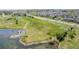 Lakefront parcel featuring a pond and dock, bordered by open fields and residential development at 14447 Madison St, Thornton, CO 80602