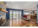 Cozy living room featuring a brick fireplace, hardwood floors, and natural light at 14447 Madison St, Thornton, CO 80602