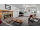 Comfortable living room with a brick fireplace, cozy seating, and a mounted TV at 14447 Madison St, Thornton, CO 80602