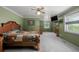 Spacious main bedroom with green walls, neutral carpet, windows, and a ceiling fan at 14447 Madison St, Thornton, CO 80602