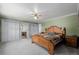Spacious main bedroom with green walls, white carpet, and a wooden bed and dressers at 14447 Madison St, Thornton, CO 80602