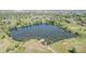 Scenic pond featuring a dock and clear water, set amidst a sprawling landscape at 14447 Madison St, Thornton, CO 80602