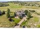 Expansive home overlooks a golf course with lush greenery, complemented by a long driveway and well-manicured grounds at 5192 Sedona Dr, Parker, CO 80134