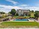 Expansive backyard with a pool, patio, and a lush green lawn at 5192 Sedona Dr, Parker, CO 80134