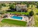 Backyard aerial view of pool, patio, and lounge area with view of neighborhood at 5192 Sedona Dr, Parker, CO 80134