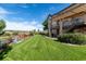Expansive backyard features a lush lawn, pergola covered patio, and glimpses of a pool, perfect for outdoor living at 5192 Sedona Dr, Parker, CO 80134