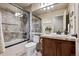 Bright bathroom with a glass shower, decorative tile and a single sink vanity at 5192 Sedona Dr, Parker, CO 80134
