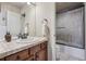 Well-lit bathroom featuring a vanity with tile countertop and a shower-tub combination with tiled walls at 5192 Sedona Dr, Parker, CO 80134